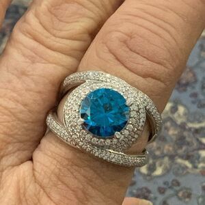 Stunning round Blue Zircon ring swirling with white CZs. Very pretty
